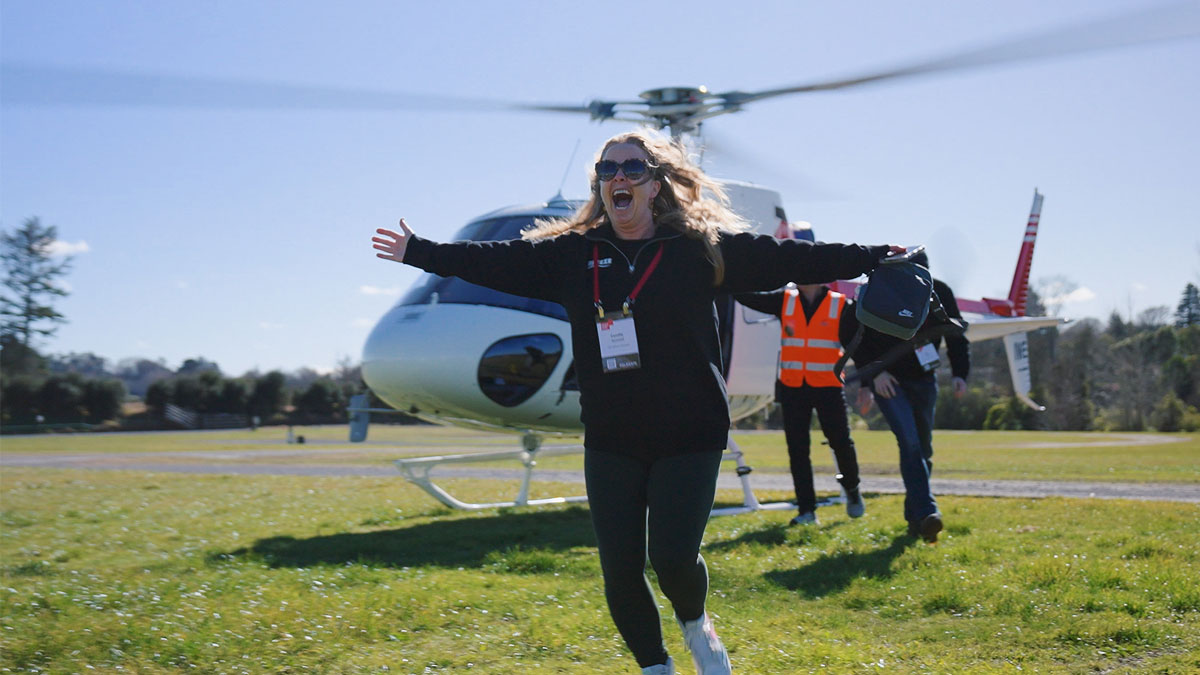 An attendee running from a helicopter at EROAD Fleet Days 2026